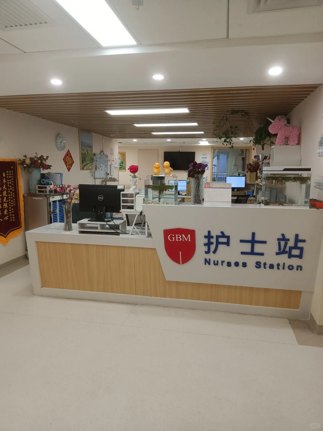 Nurses station at Beijing Boren Hospital with GBM logo and warm welcoming decor