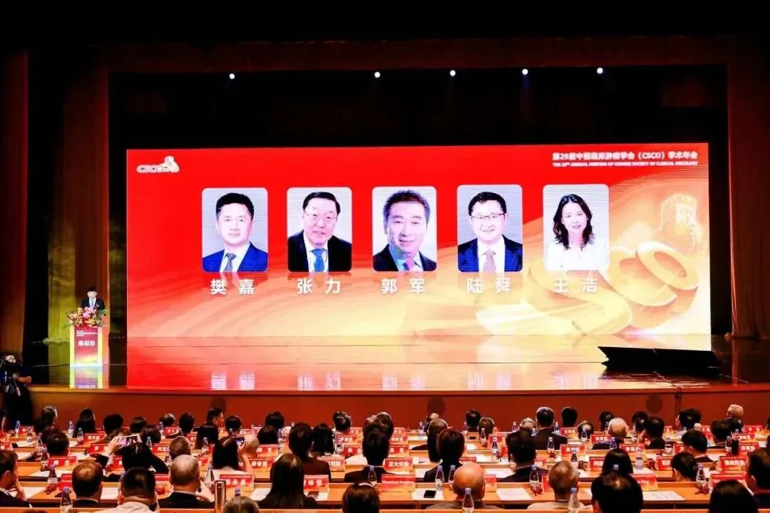 CSCO 2026 faculty portraits displayed on the main stage of the congress