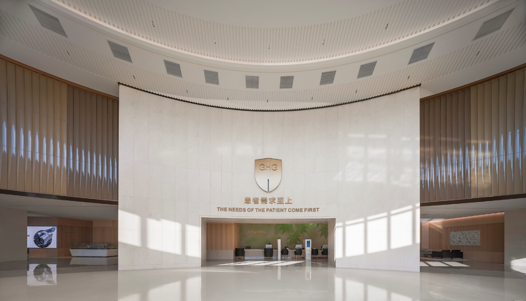 Beijing GOBROAD Boren Hospital lobby with the inscription 'The Needs of the Patient Come First'